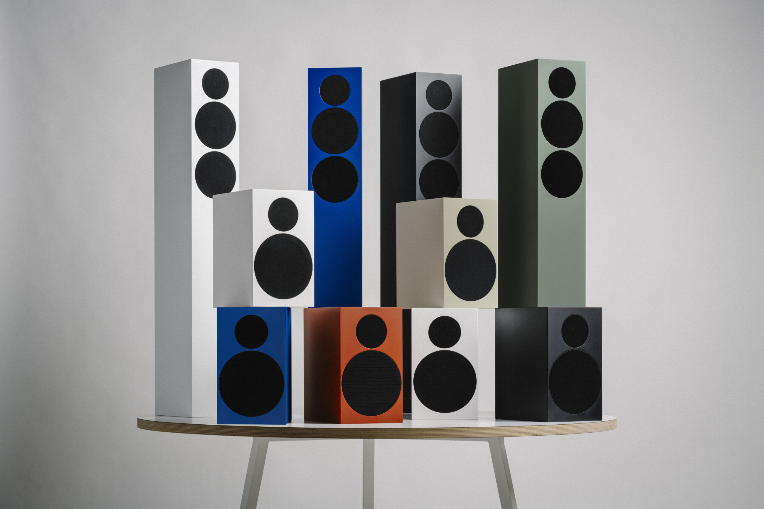 Tone Speaker L and S displayed on a white table in various satin colors